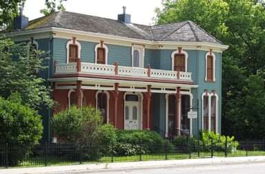Discover a picturesque Victorian home with a beautifully detailed facade and lush greenery.